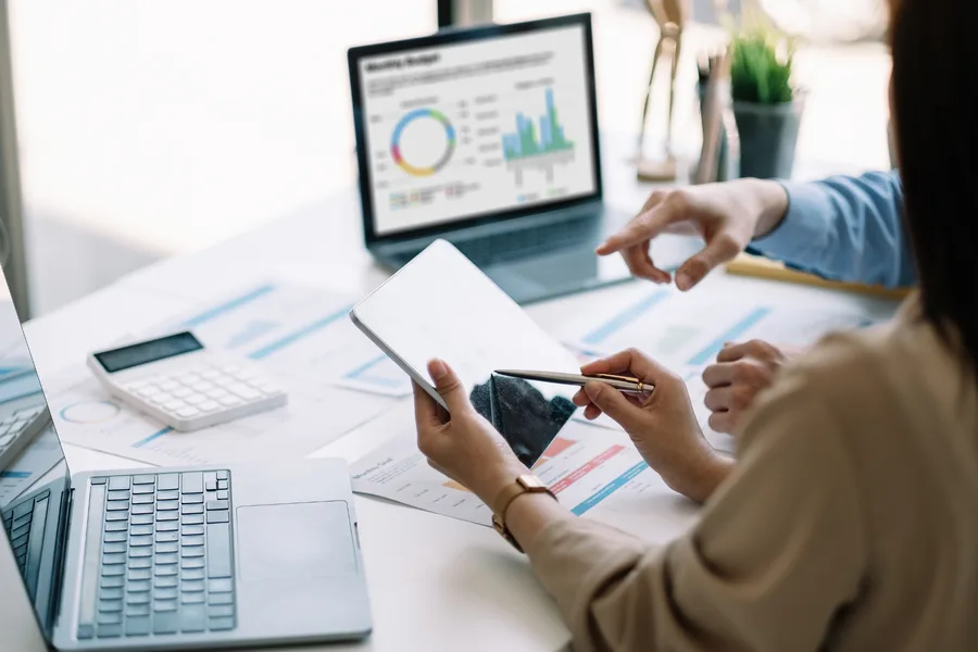 Reviewing project charts and figures together at a desk